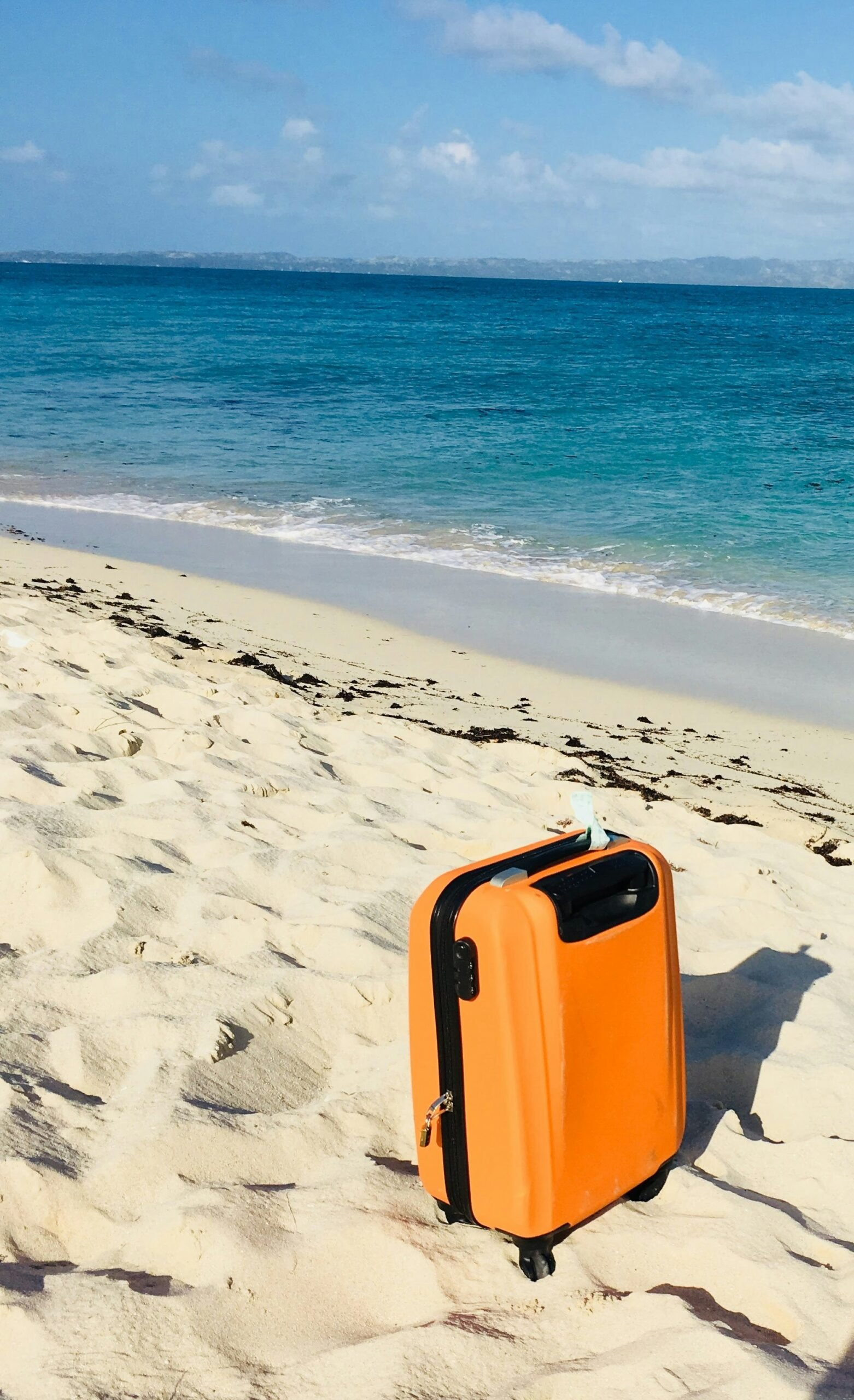 Suitcase on the beach ready for a sailing trip